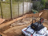 Using the old stones in preparation for  the new patio.